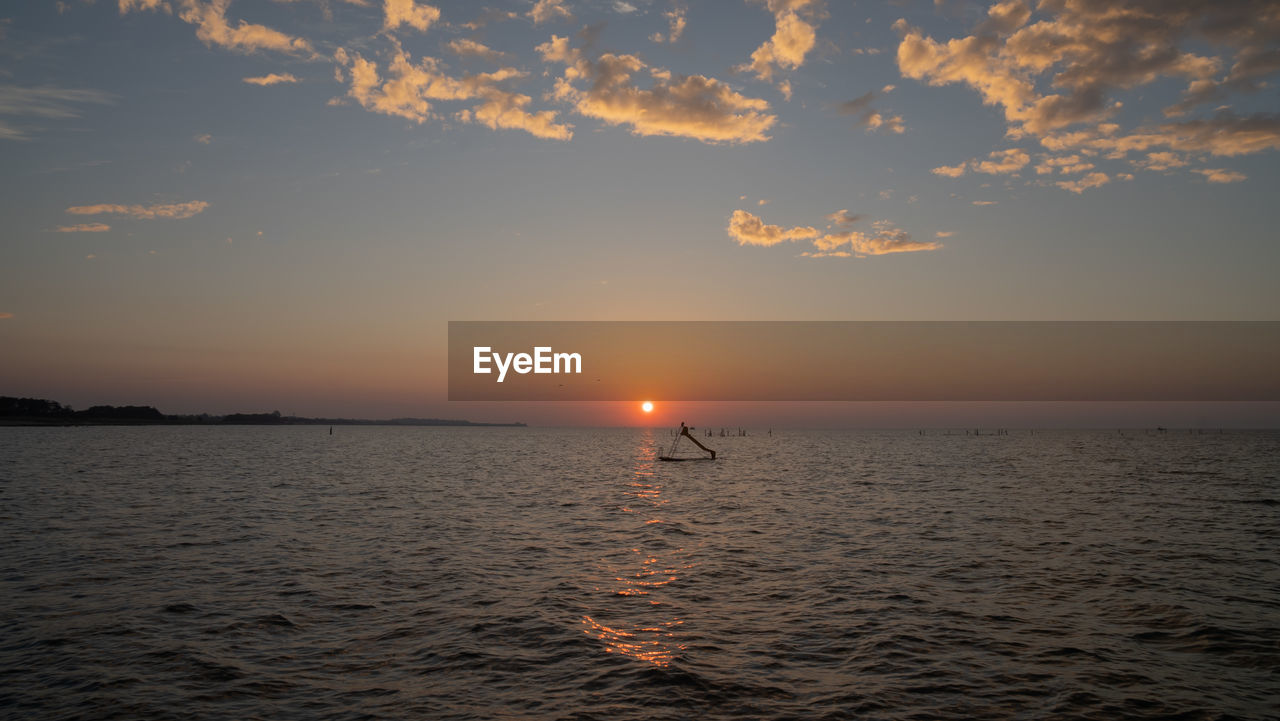 SCENIC VIEW OF SEA AGAINST ORANGE SKY