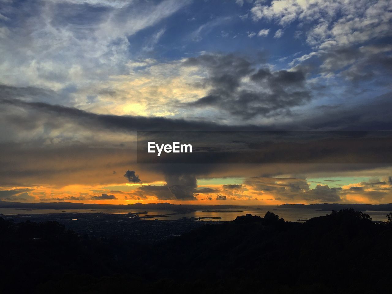 DRAMATIC SKY OVER SILHOUETTE LANDSCAPE