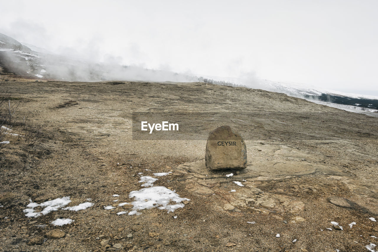 High angle view of text on rock over field during winter