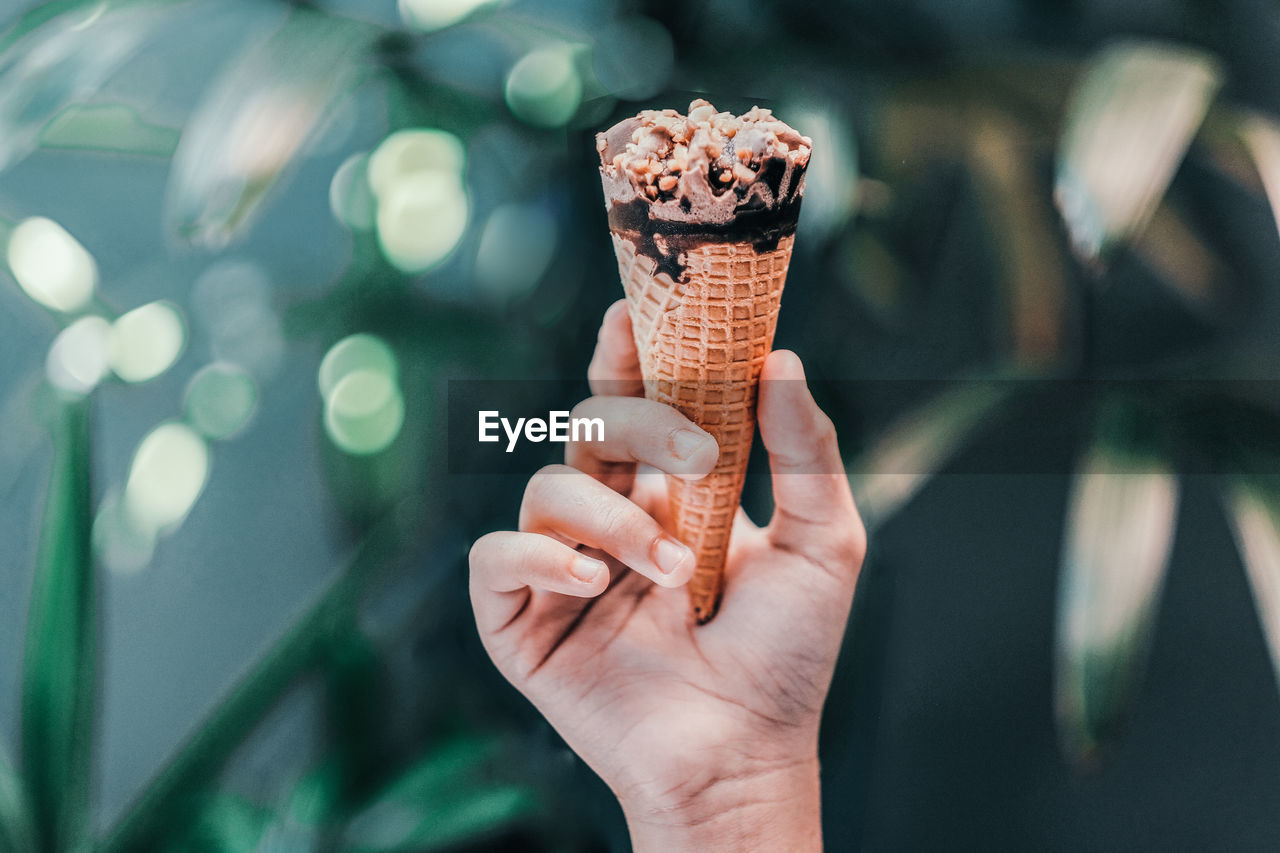 Close-up of hand holding ice cream cone