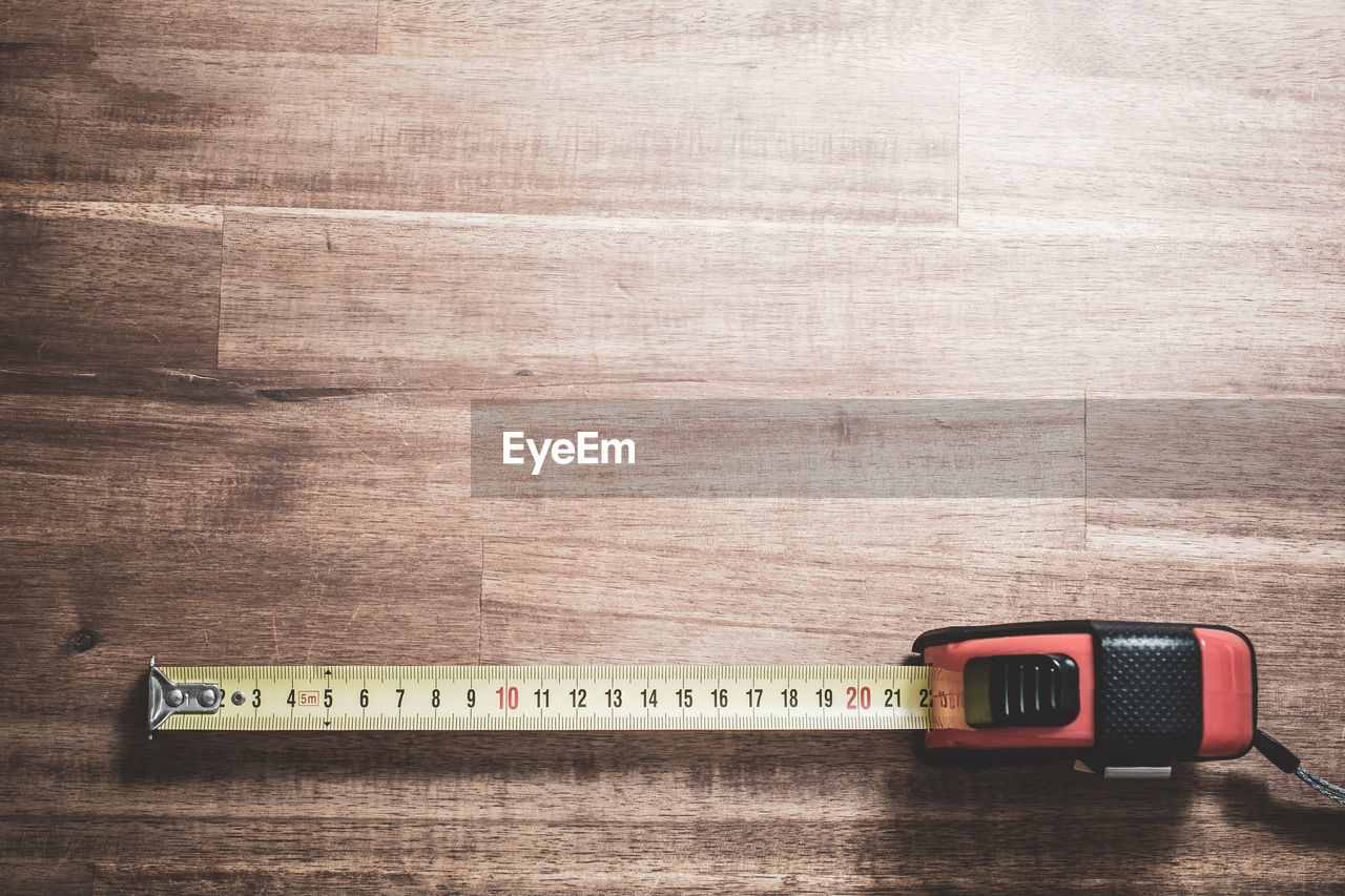 High angle view of tape measure on wooden table