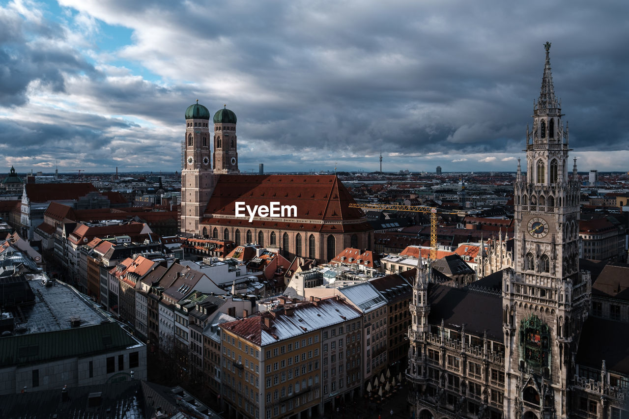 High angle view of buildings in munich city against cloudy sky, in view the frauenkirche