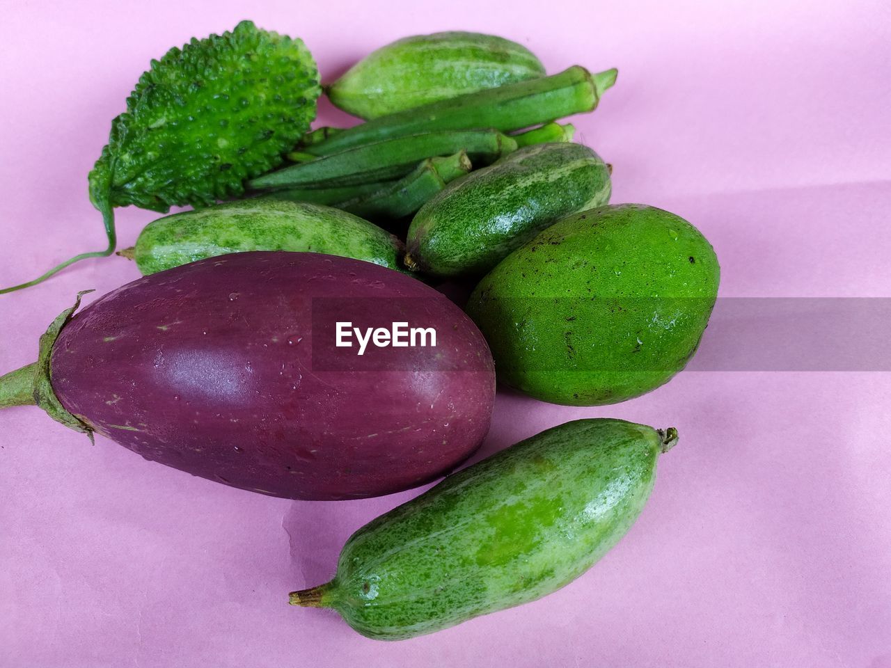 Indian summer vegetables on pink background.