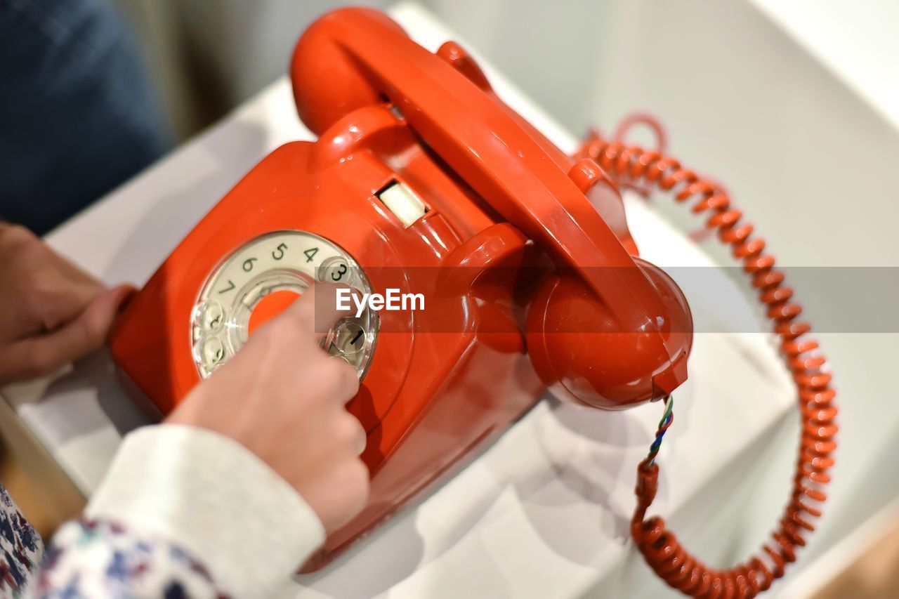 Cropped hand dialling on telephone