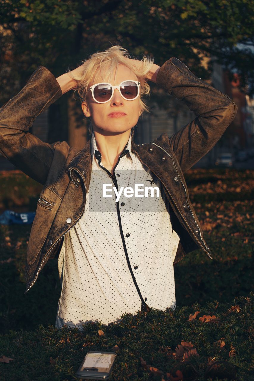 Portrait of mid adult woman wearing sunglasses while standing outdoors