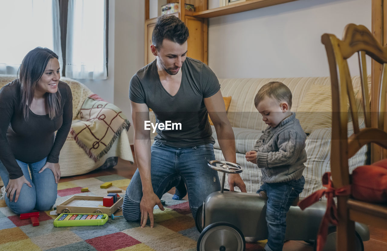 Parents playing with son at home