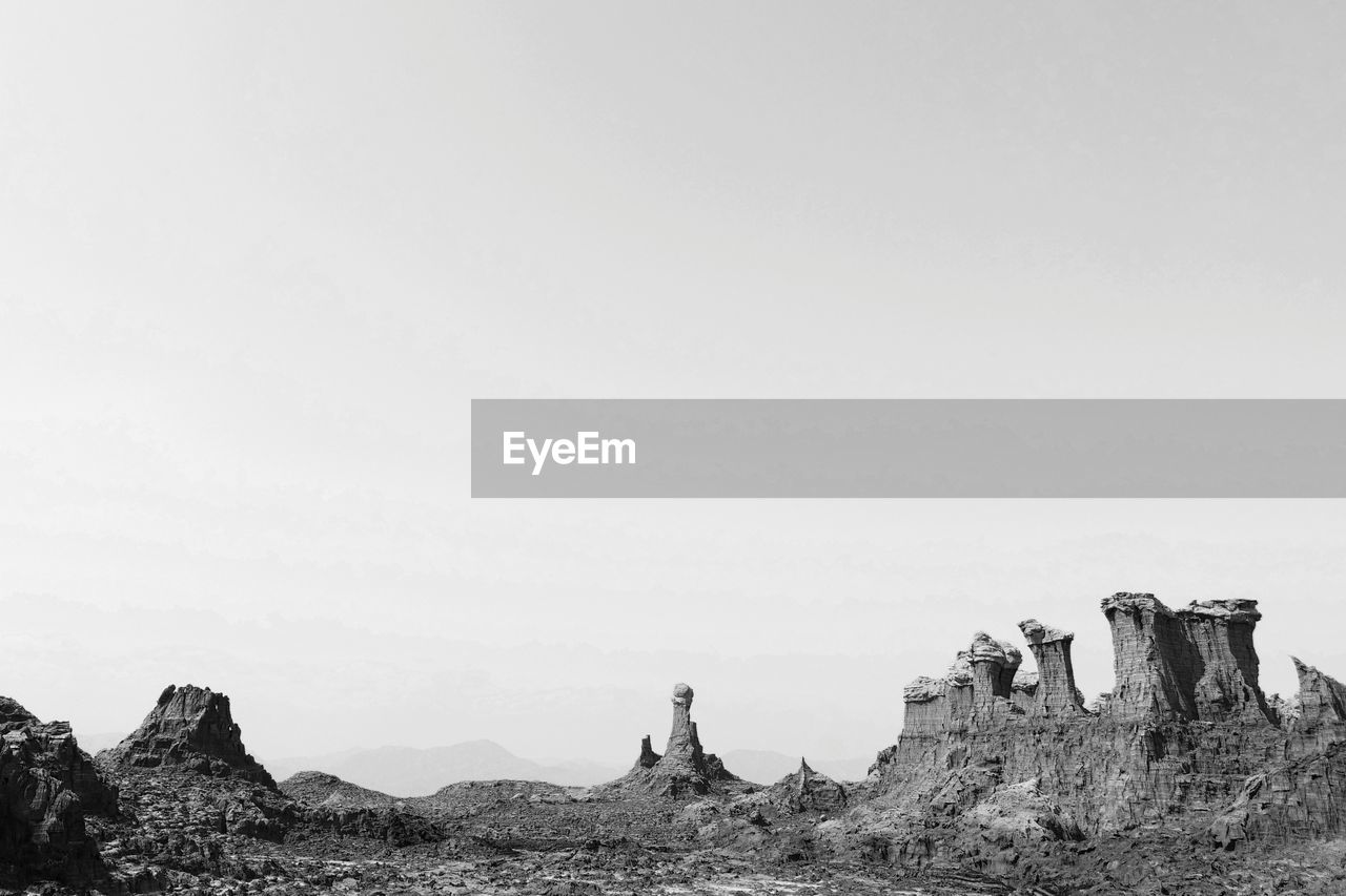 PANORAMIC VIEW OF ROCKS AGAINST CLEAR SKY