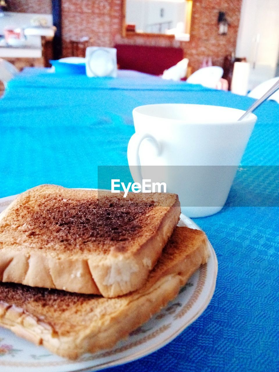 CLOSE-UP OF CUP OF COFFEE WITH BREAD AND DRINK