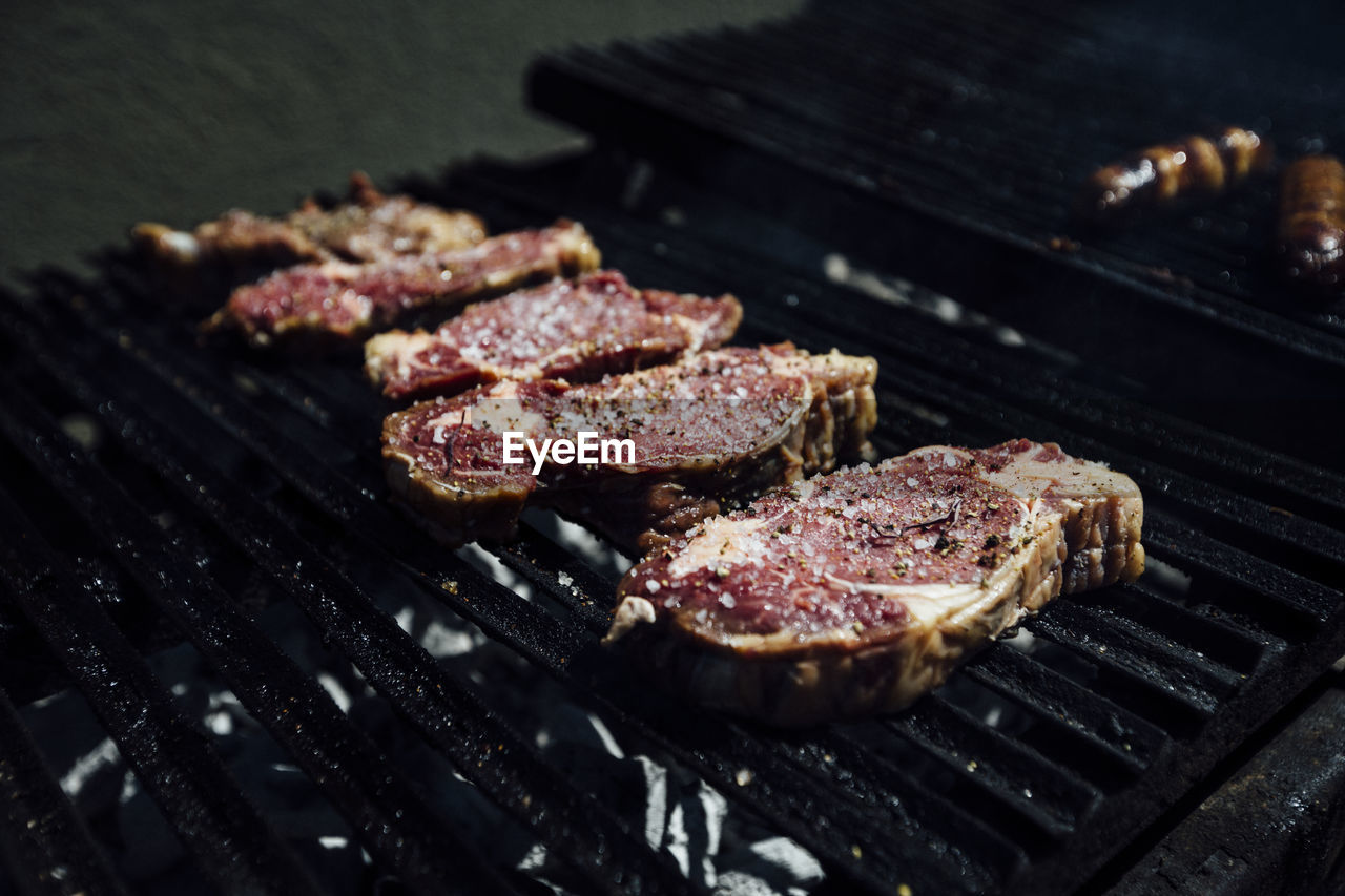 High angle view of meat on barbecue grill