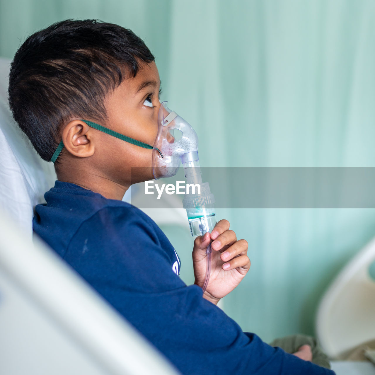 Boy wearing nebulizer at hospital