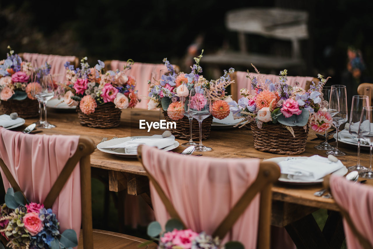 Wedding table decoration and seating with flowers and roses and plate