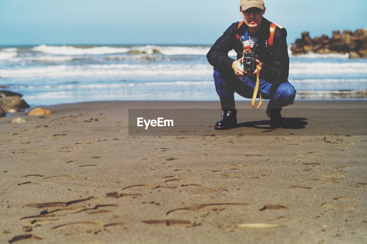 Full length of boy playing at beach