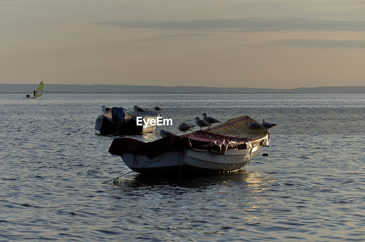 BOAT IN SEA AGAINST SKY