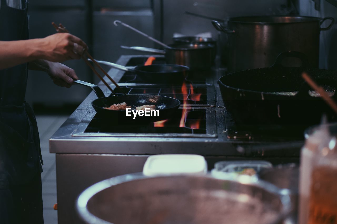 Cropped hand preparing food in kitchen