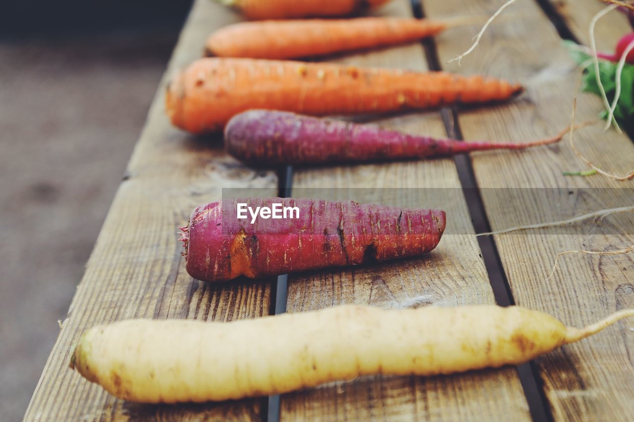 High angle view of carrots in different colors on table