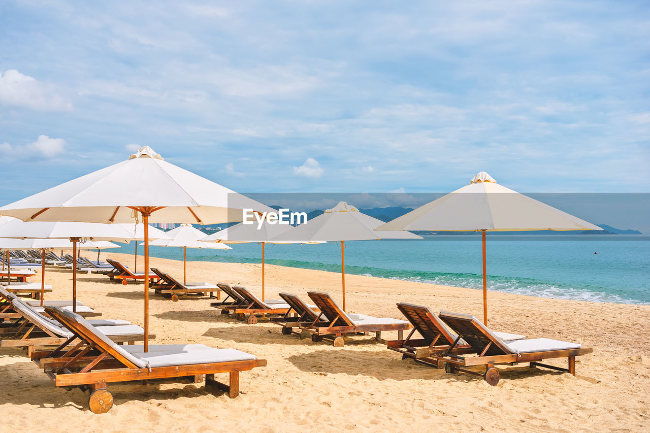 CHAIRS ON BEACH AGAINST SEA