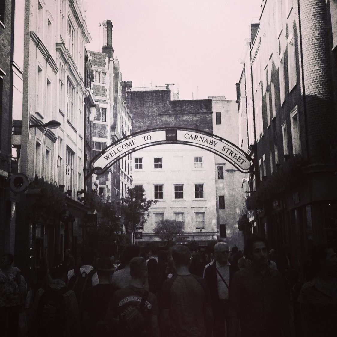 People walking on road along buildings