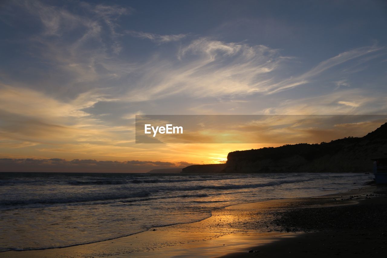 Scenic view of beach against sky during sunset