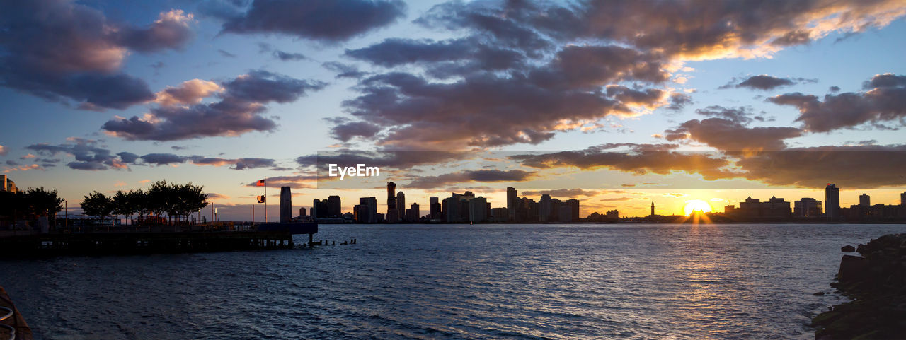 Scenic view of silhouette buildings against sky during sunset