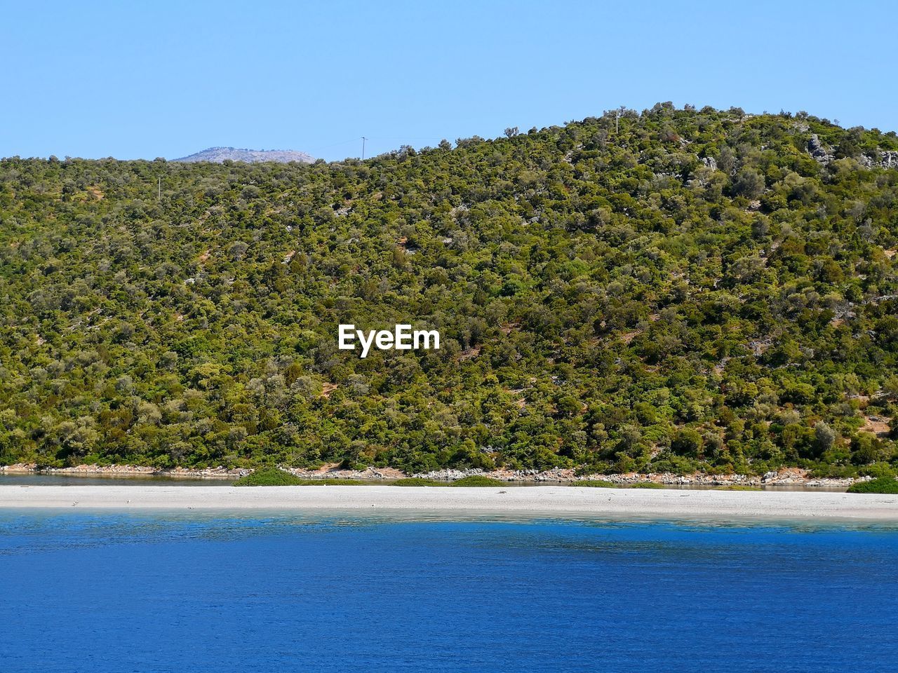 Scenic view of sea against clear blue sky