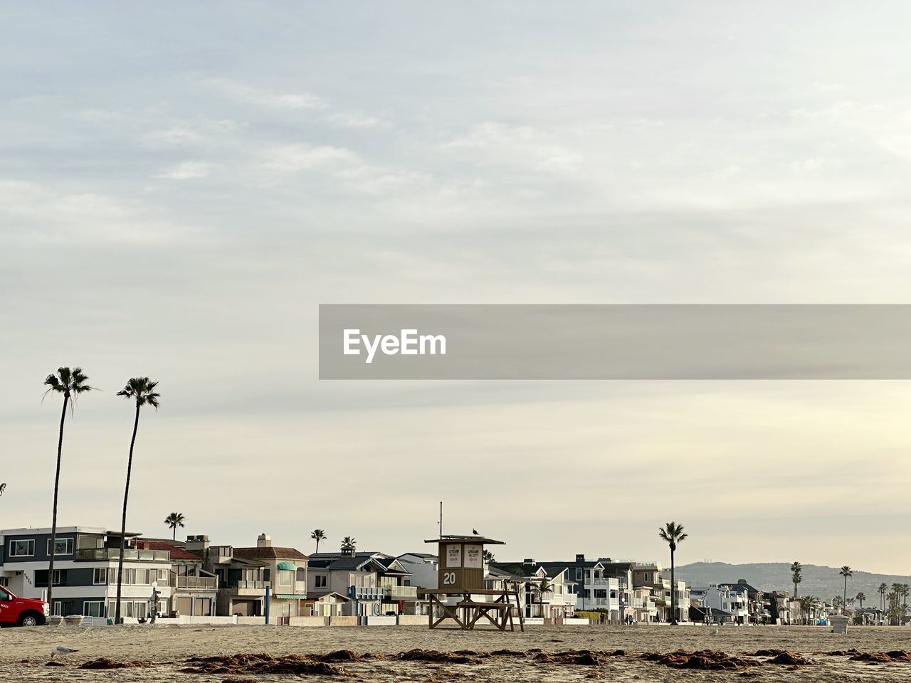 sky, sea, beach, coast, cloud, architecture, nature, horizon, built structure, land, shore, building exterior, water, city, ocean, day, body of water, walkway, outdoors, sand, transportation, travel destinations, no people, mode of transportation, building, travel, copy space, car