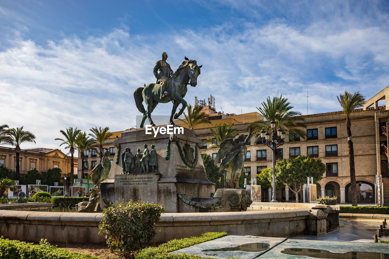 STATUE IN FRONT OF HISTORICAL BUILDING