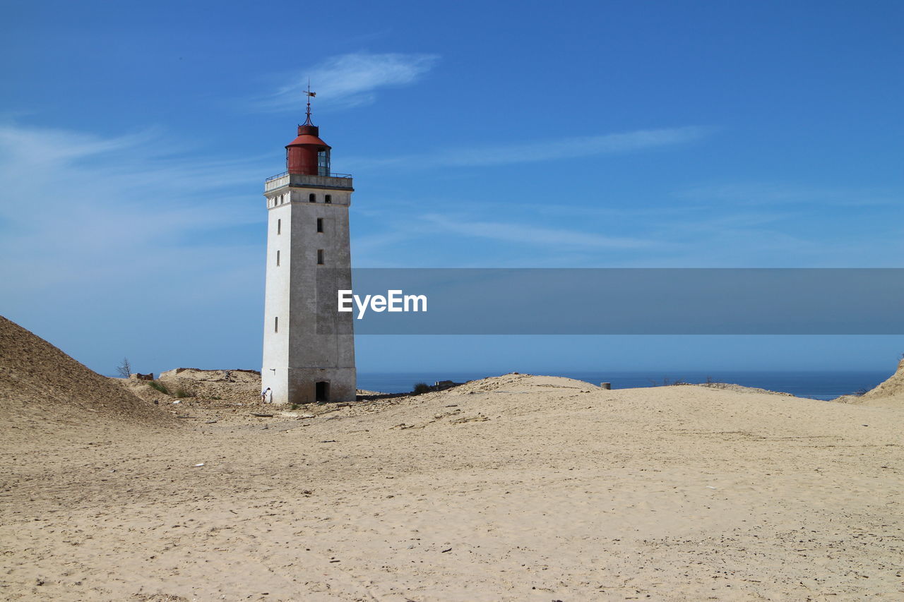 Old lighthouse against blue sky