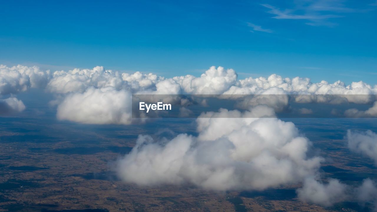 Aerial view of volcanic landscape against blue sky