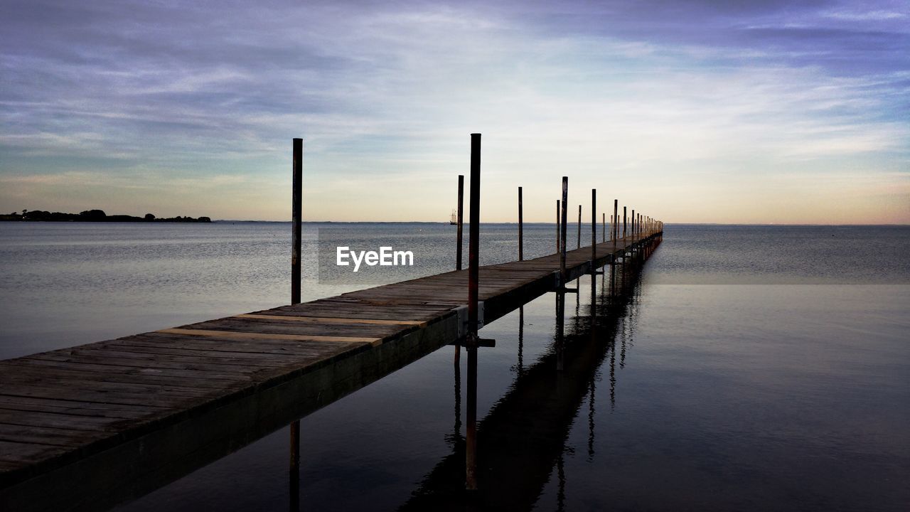 Pier over sea against sky