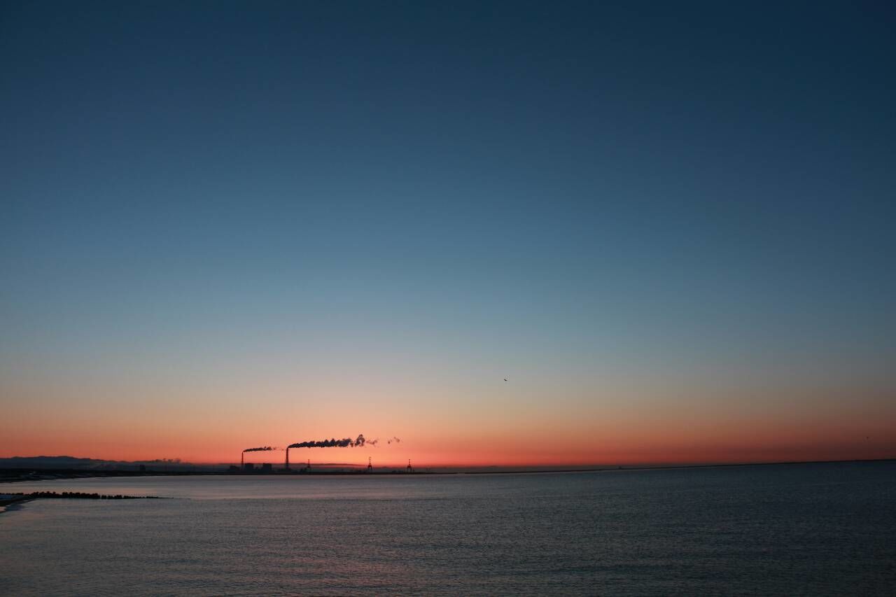 Scenic view of sea against clear sky at dusk