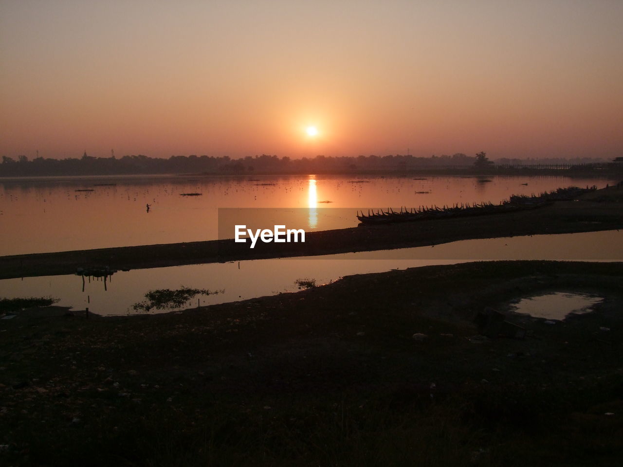 SCENIC VIEW OF SUNSET OVER LAKE