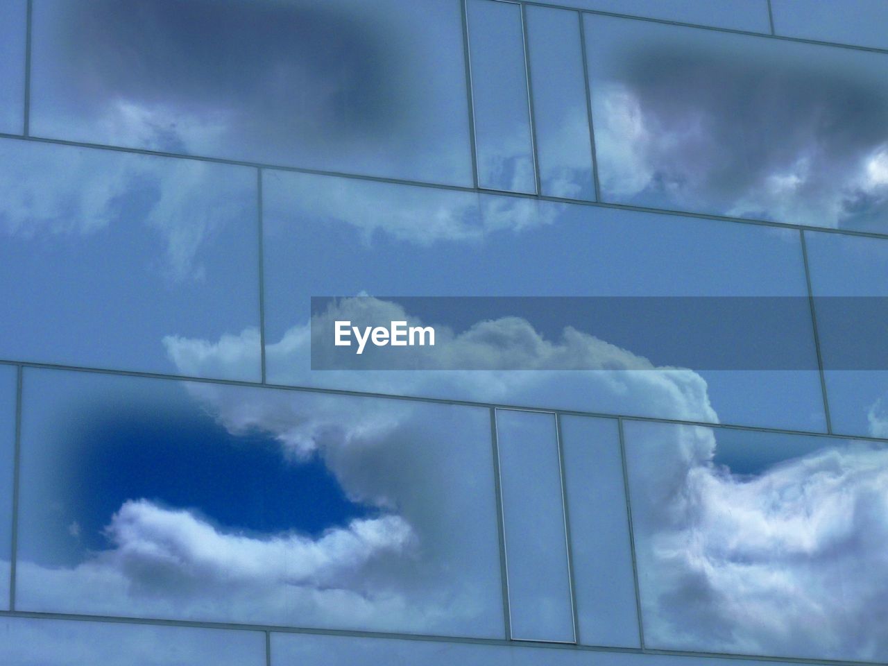 LOW ANGLE VIEW OF POWER LINES AGAINST CLOUDY SKY