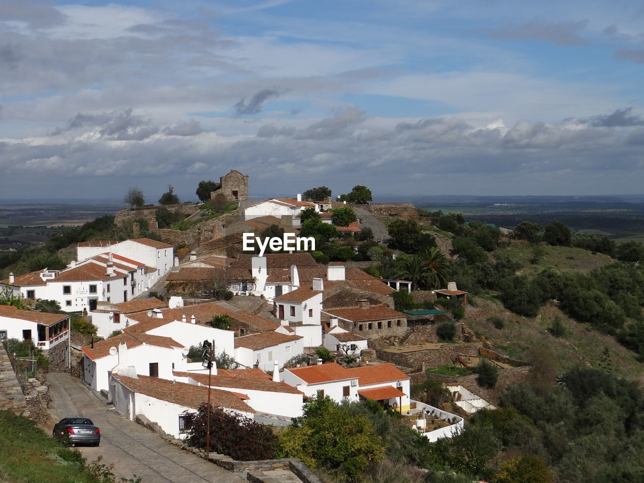 High angle view of houses by sea against sky