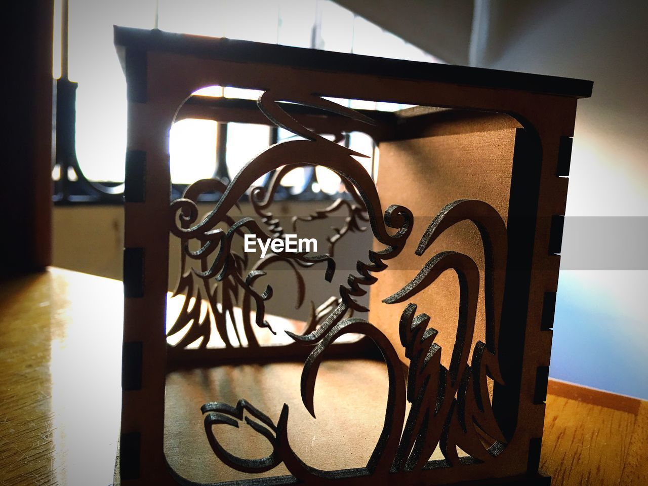 CLOSE-UP OF EYEGLASSES ON WOOD AT TABLE