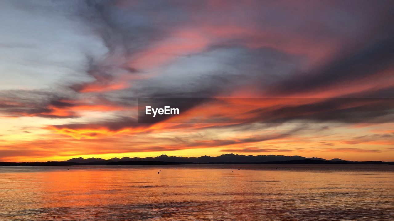 Scenic view of dramatic sky over sea during sunset