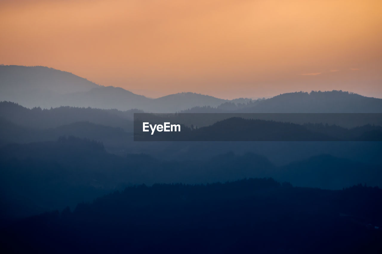 Scenic view of silhouette mountains against sky during sunset