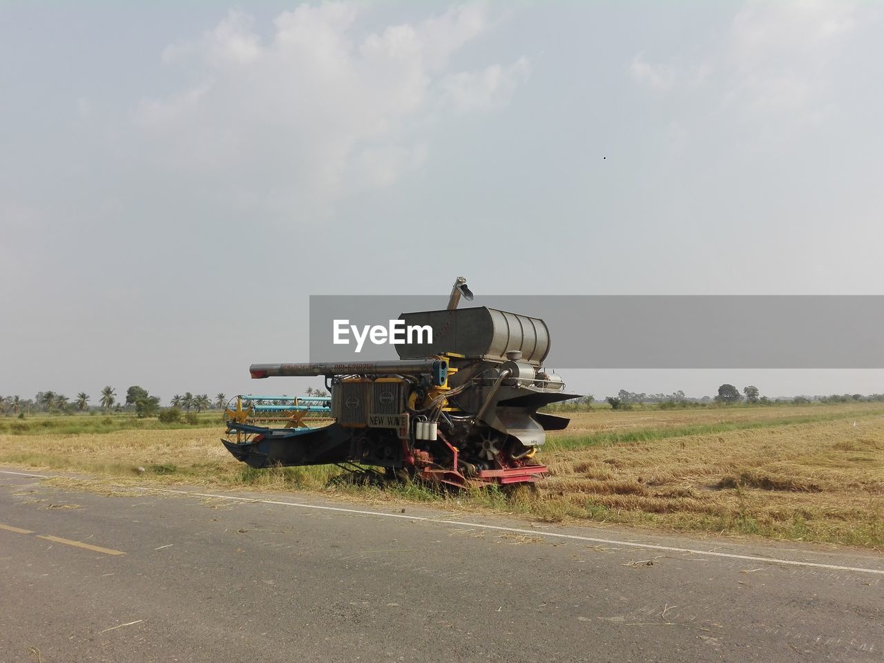 transportation, transport, asphalt, road, mode of transportation, landscape, sky, rural scene, nature, environment, vehicle, rural area, land vehicle, agriculture, day, field, machinery, agricultural machinery, land, cloud, no people, outdoors, farm, agricultural equipment, highway, occupation