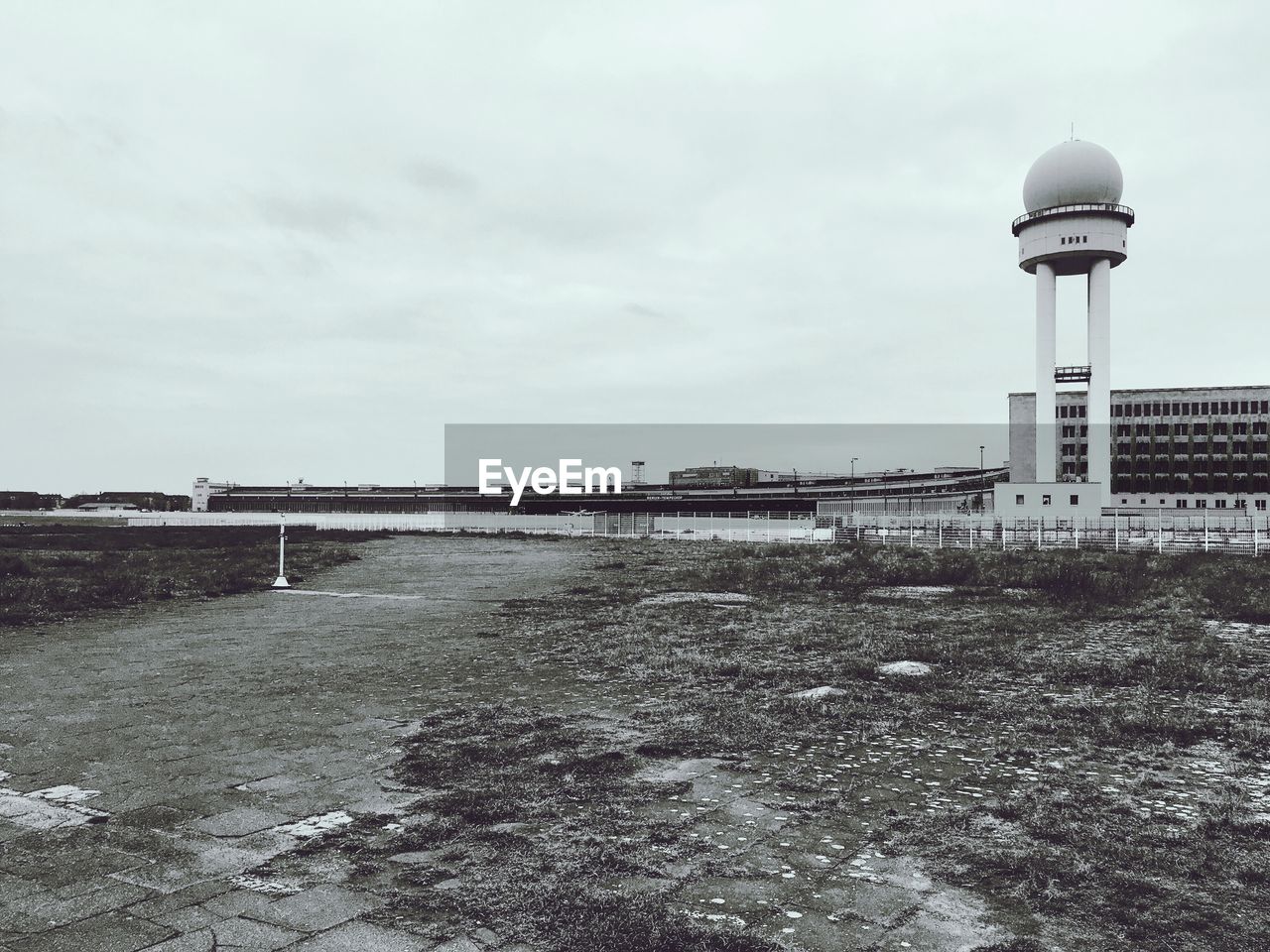 Airport building against cloudy sky