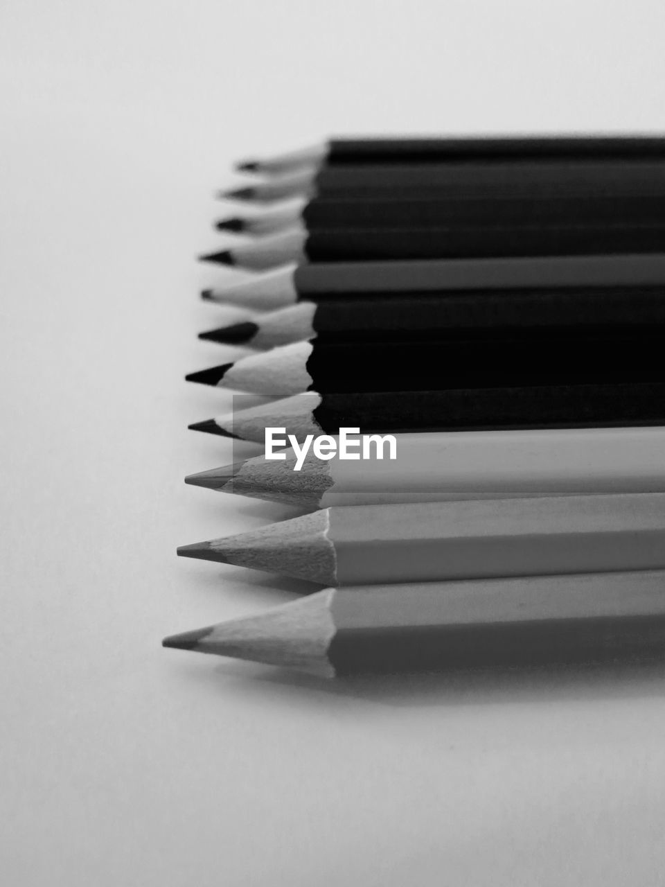 Close-up of pencils over white background