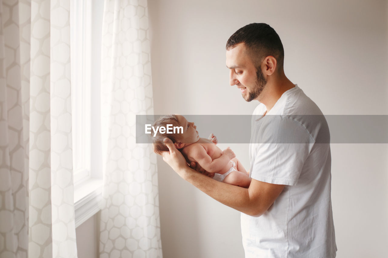 Side view of man playing with daughter