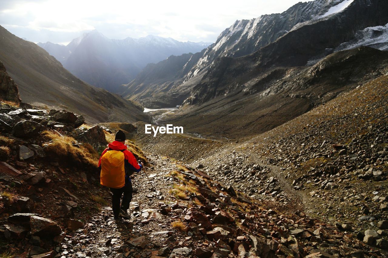 Rear view of man hiking on mountain