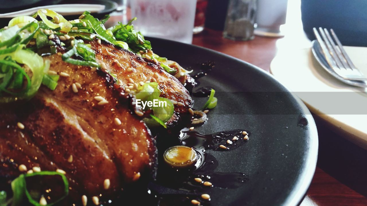 Close up of fried meat with herbs on plate