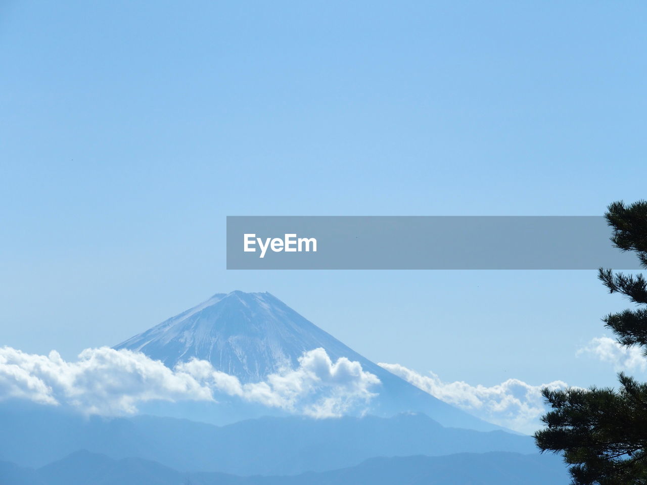 Scenic view of snowcapped mountains against clear blue sky