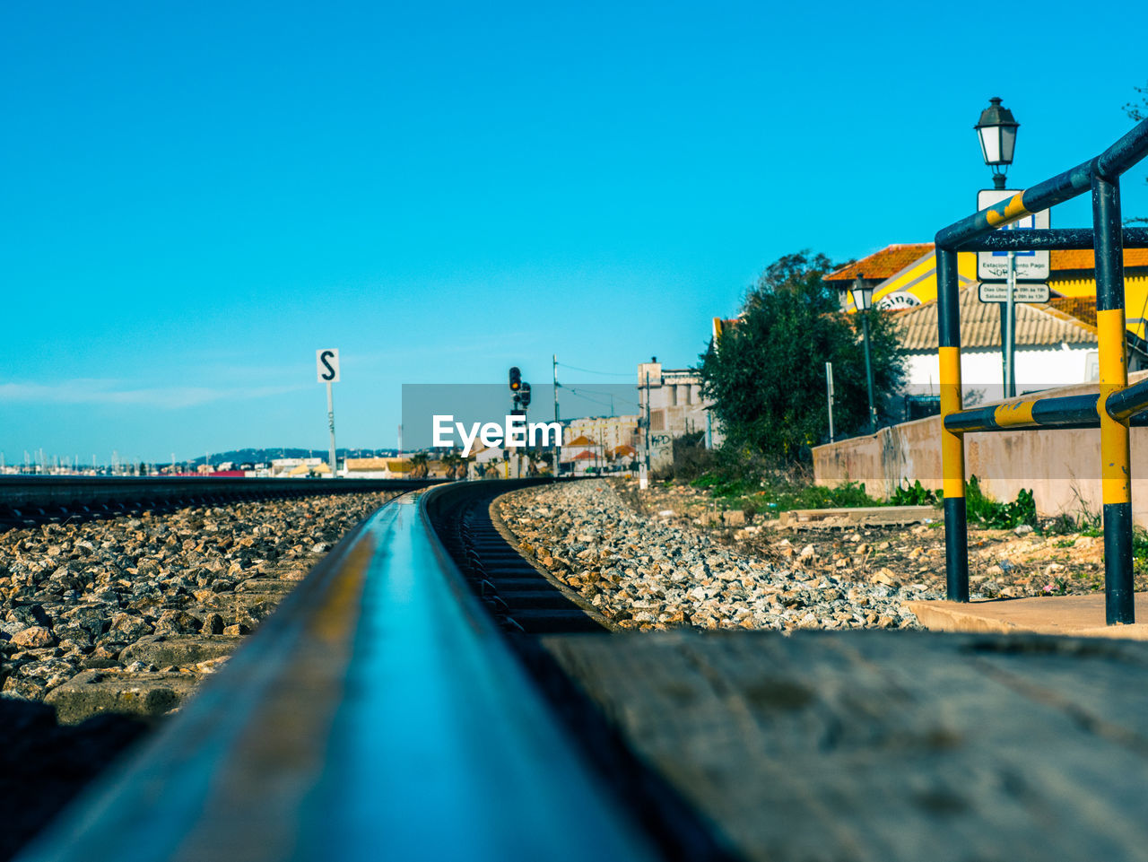 SURFACE LEVEL OF RAILROAD TRACK AGAINST CLEAR BLUE SKY