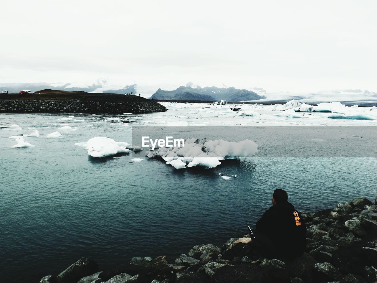 SCENIC VIEW OF FROZEN LAKE AGAINST SKY