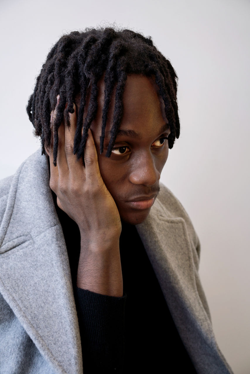 Stylish black man wearing coat portrait