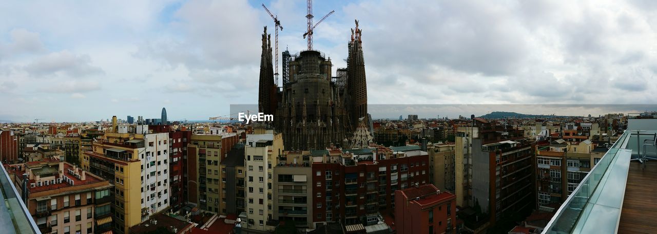 Cityscape against cloudy sky