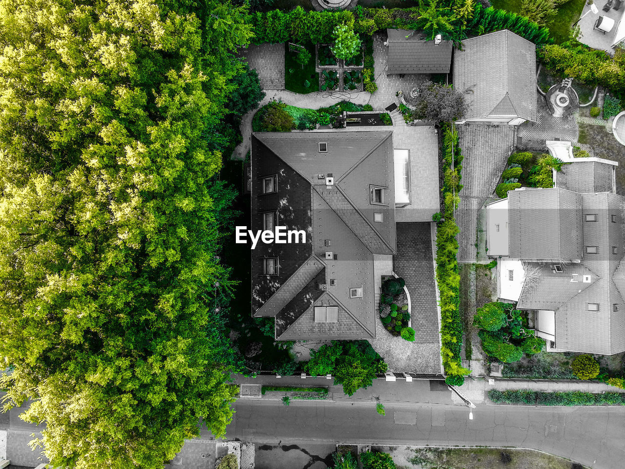 HIGH ANGLE VIEW OF BUILDING AND TREES BY WINDOW