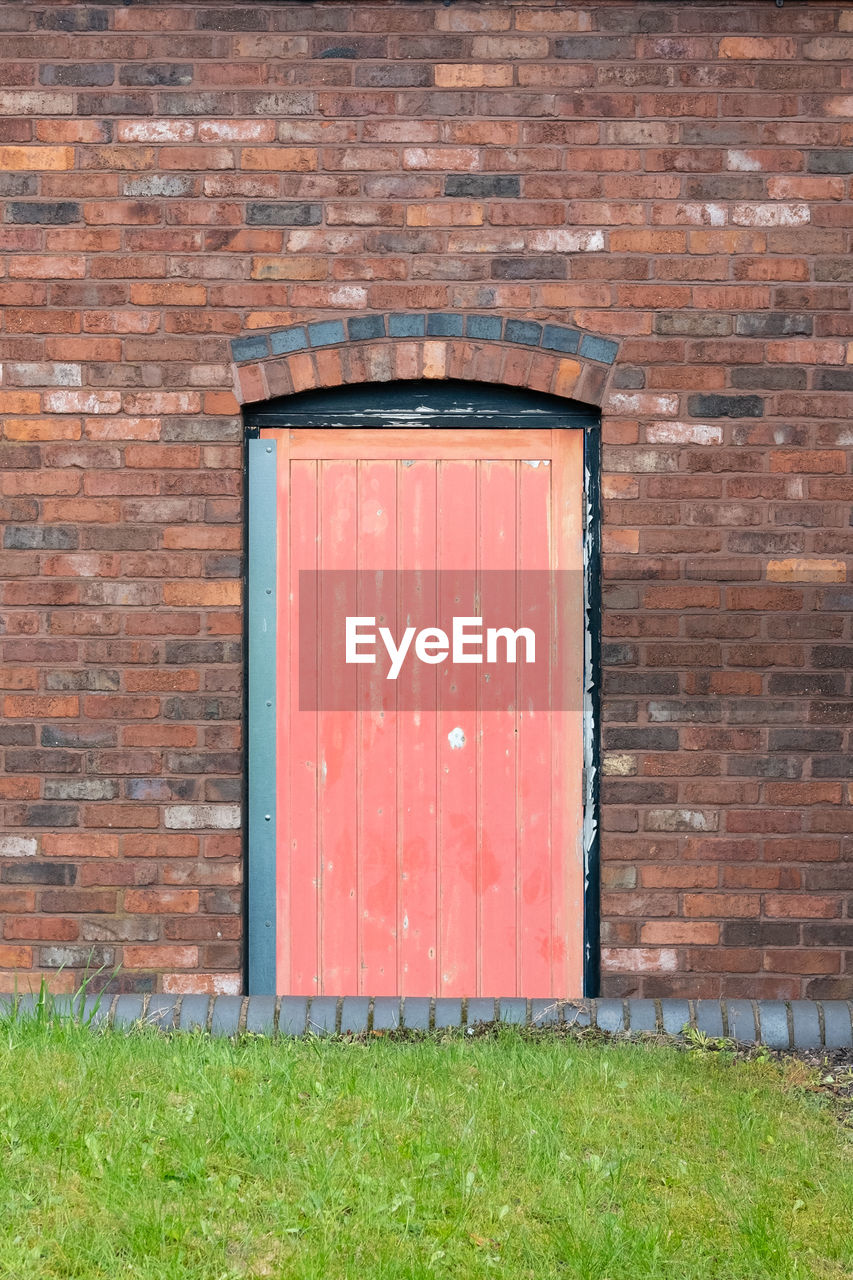 architecture, built structure, building exterior, door, entrance, closed, day, wood, brick, no people, grass, barn, wall - building feature, brick wall, wall, plant, building, red, protection, brown, security, outdoors, green, house, nature, old, window, facade, brickwork