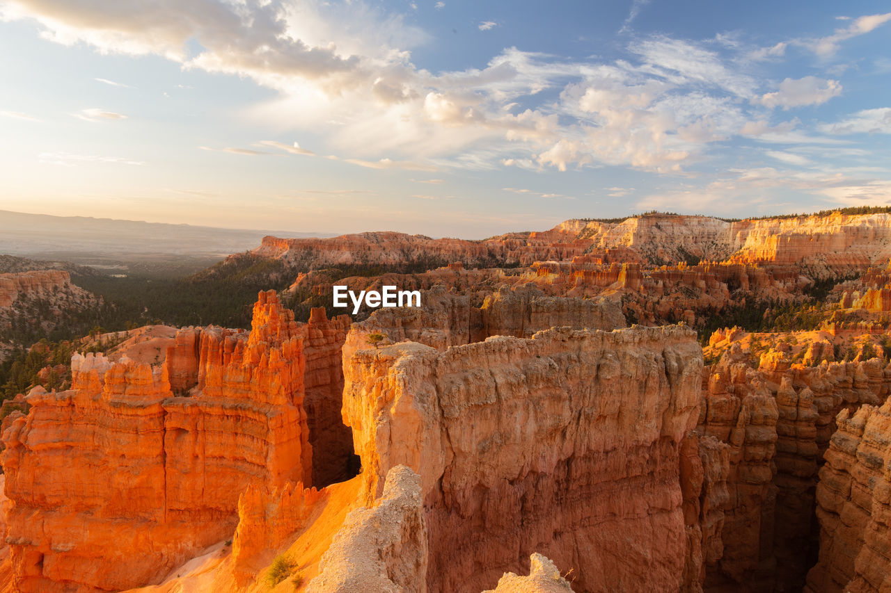 Scenic view of rock formations against cloudy sky